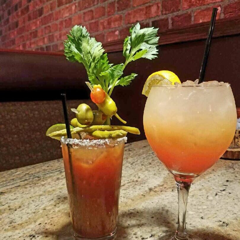 Two glasses of drinks on a table